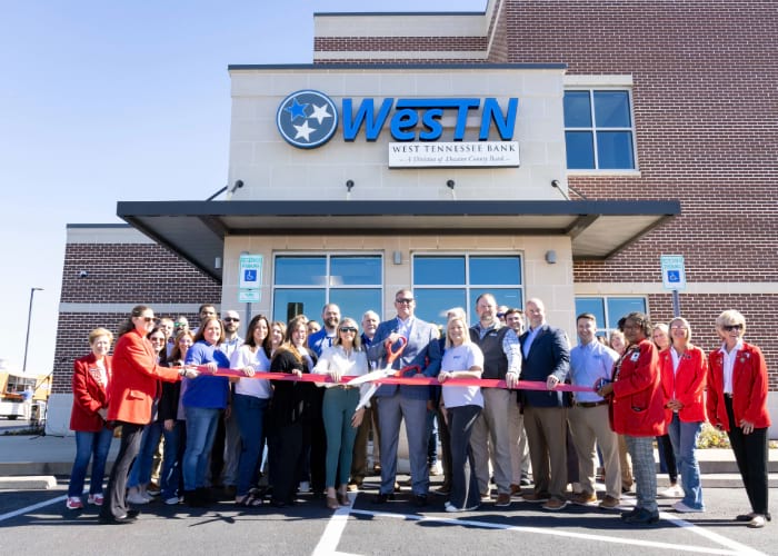 West Tennessee members cutting rope in front of bank building