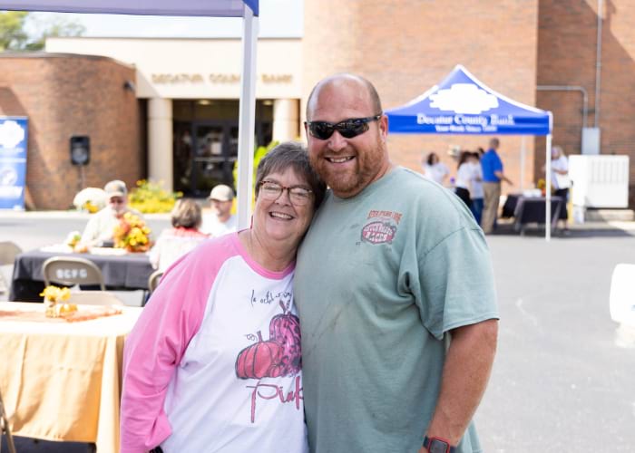 man and woman smiling at the camera