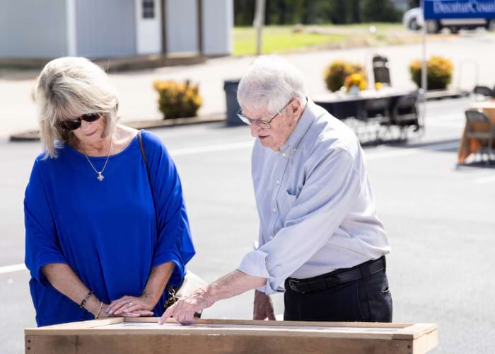 Elderly couple looking at plaques