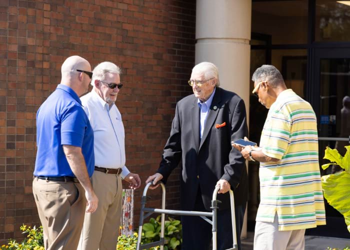 group of men talking in front of building