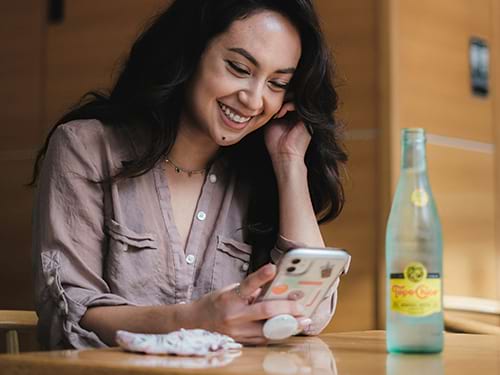A lady smiling at something on her phone