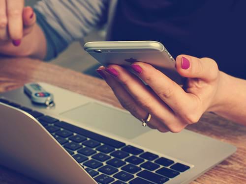 A lady looking at something on her phone
